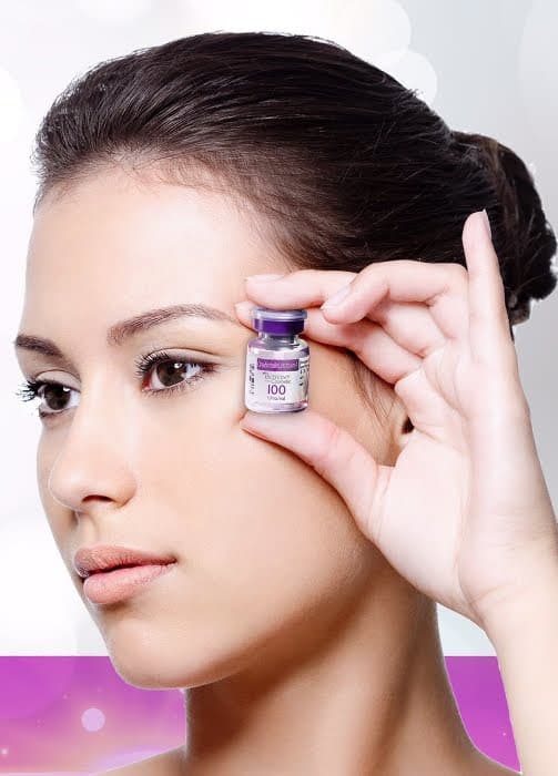 Image of a beautiful model holding Botox® botulinum toxin anti-wrinkle injection vial upto her face